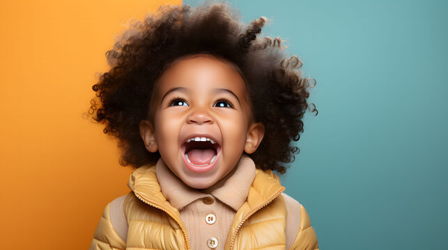 Excited african american little girl looking at camera on colorful background