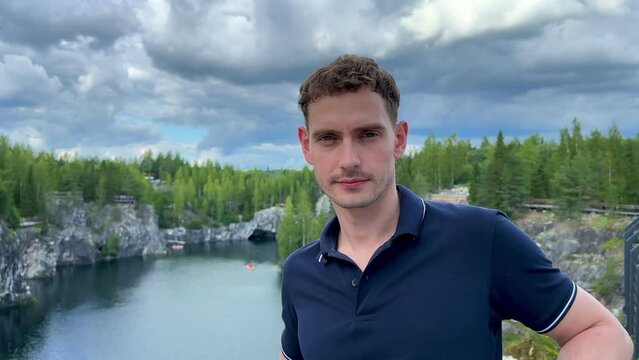 Happy young man background Marble canyon in Ruskeala, Karelia