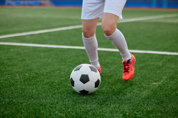 sports girl football player with a soccer ball on the soccer field, the concept of professional women's football