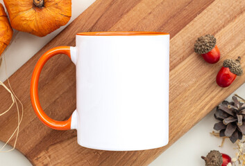 White cup with orange inside and handle with pumpkins . Orange handle mug mockup your fall or halloween design