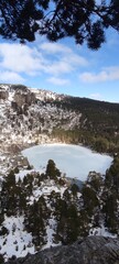 Vertical image of a frozen lake in a snowy landscape.La Laguna Negra, Soria, España.