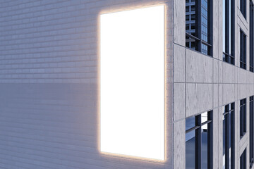 Illuminated white billboard with mock up place for advertisement on modern building exterior. 3D Rendering.