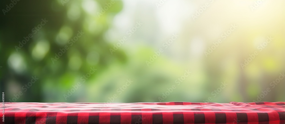Poster green bokeh from garden in morning background with red checkered tablecloth for key visual layout
