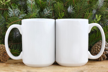 2 White 15 oz white mug on a green christmas background  . Front - Back 15 oz cups mock up