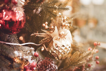 New Year's decor. Bright Christmas background. Christmas tree with decorative toys and garlands...