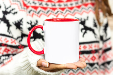 Girl is holding red handle white 11 oz mug in hands with Christmas sweater. Blank ceramic cup xmas