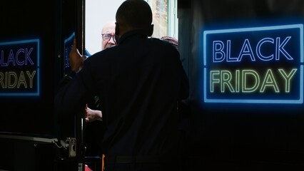 Mad clients breaking into shop during black friday sales at department store, pushing security agent and forcing to enter outlet. Crazy aggressive customers outside shopping center. Tripod shot.