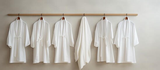 Indoor rack with hanging clean white bathrobes