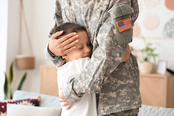 Female soldier with her little son hugging at home, closeup - obrazy, fototapety, plakaty