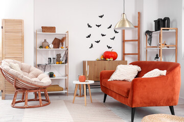 Interior of living room decorated for Halloween with red sofa and armchair