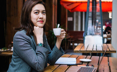 Freelancer looking at camera with cup in hand