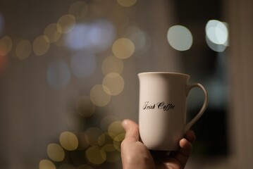 hand holding cup , Man holding a white cup of hot beverage 