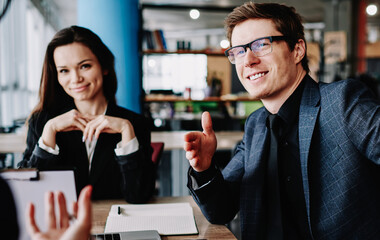 positive prosperous businessman in elegant suit communicating with partners