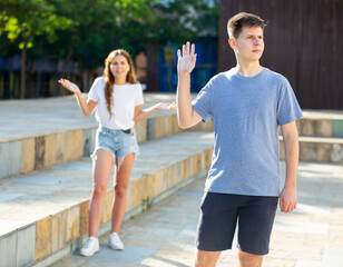 Fototapeta premium Guy was offended by the girl after quarrel on the street