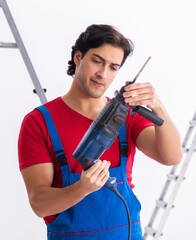 Young handsome contractor working indoors
