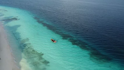 Cercles muraux Plage de Nungwi, Tanzanie Aerial drone view of sailing boat on clear turquoise water of Indian ocean on Zanzibar island. Beach and coral reef can also be spotted. Nungwi beach, Zanzibar, Tanzania