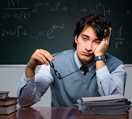 Young math teacher in front of chalkboard