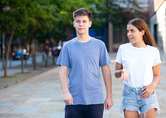 Teenagers are communicating on walk on the street