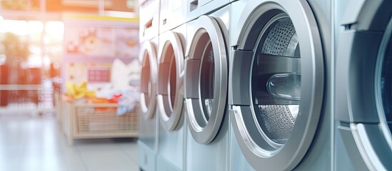 Focus on second washing machine cover with blurred vending machine background in laundry shop