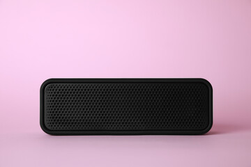One portable bluetooth speaker on pink background. Audio equipment