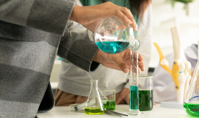 Children scientist doing science experiment test with chemistry in a laboratory. STEM - education...