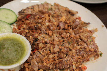 Fried Mantis shrimps with Fried Garlic and Cucumber on table background. Asian delicious seafood.