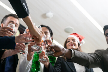 Making a toast, Cheers !! A group of diverse business people and colleagues having fun and meet up together at a business New Year party. A teamwork celebration of a successful business target.