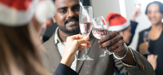 Making a toast, Cheers !! A group of diverse business people and colleagues having fun and meet up together at a business New Year party. A teamwork celebration of a successful business target.