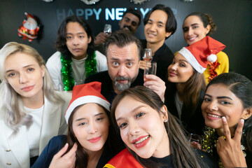 Let's take a selfie !! A group of diverse business people and colleagues having fun together at a business New Year party. A teamwork celebration of a successful.