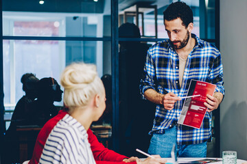 Serious caucasian male coach making workshop for business school students explaining information