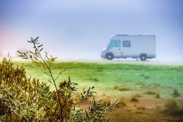 Camper rv camping on nature. Foggy day