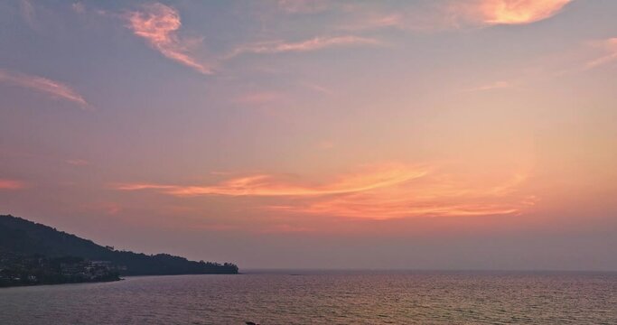 .aerial view beautiful pink light in blue sky at sunset at Kamala beach..video 4K. Nature video High quality footage. .Scene of Colorful romantic sky in sunset in the sky background.