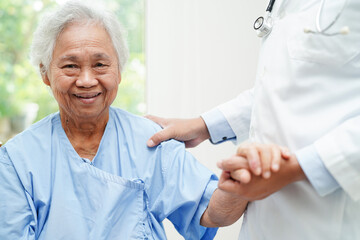 Doctor help Asian elderly woman disability patient sitting on wheelchair in hospital, medical concept.