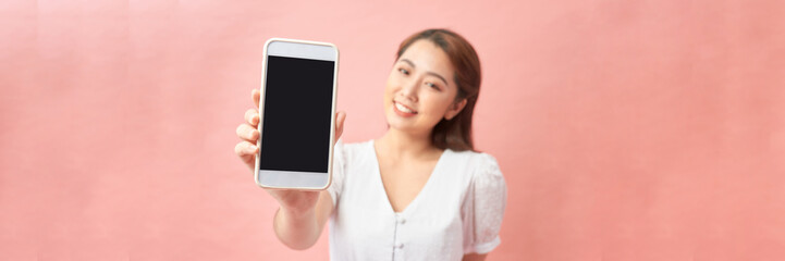 Banner wide. Beautiful Asian woman holding smartphone mockup of blank screen and smiling