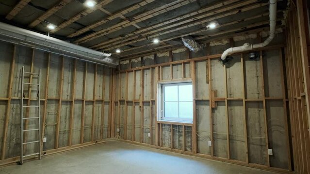 Wood building frame structure on a new development framing in basement and hvac system of new house under construction