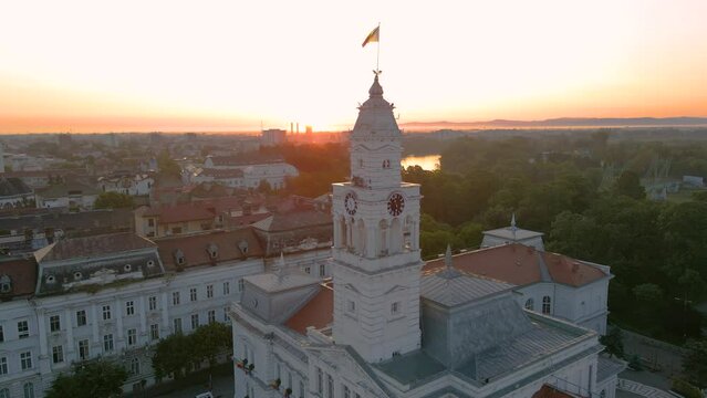 Aerial footage over Arad city center at sunrise, with the Administrative palace in the view. Video was shot from a drone, in the morning, while flying around the buildings tower with camera level.
