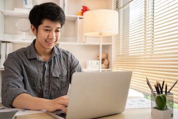 Man sat typing away on a laptop in his office with a determined look on his face, Work from the comfort of home, Male hand pressing on laptop keyboard, Work from home.