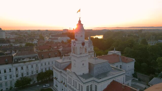 Aerial footage over Arad city center at sunrise, with the Administrative palace in the view. Video was shot from a drone, in the morning, while flying backwards from the buildings clock tower.