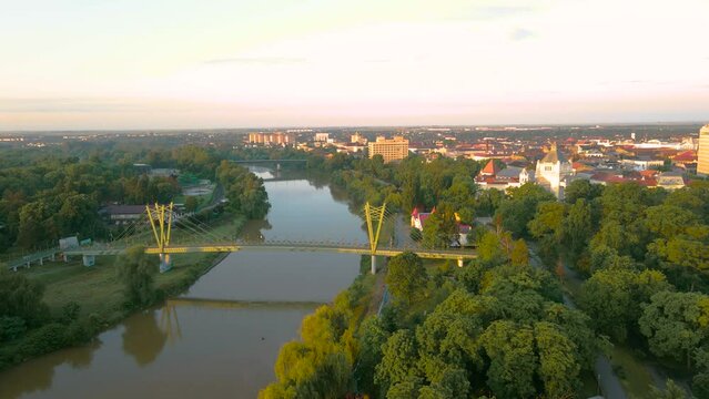 Aerial footage over Arad city center above the Mures river. Video was shot from a drone, in the morning, while flying forward towards and above a bridge.