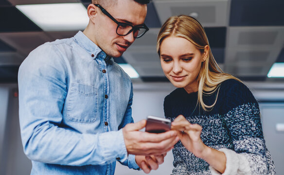 Hipster students watching video in social networks on cellular