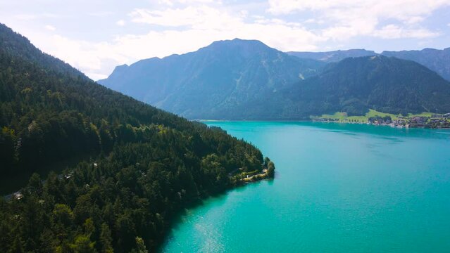 Birds eye view of the Achen Lake in Tyrol, Austria. Video of the lake was shoot from a drone at level altitude while flying towards left side.
