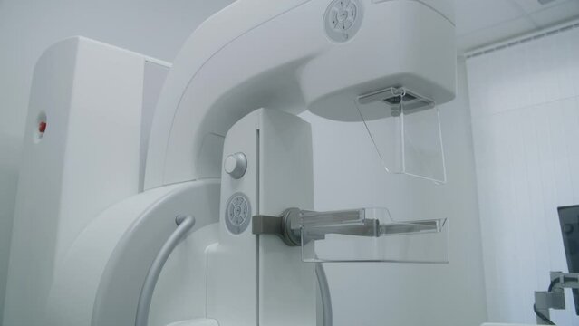Bright hospital radiology room. Digital mammogram X-Ray scanning machine for mammography screening procedure in clinic. Professional equipment for breast cancer prevention in modern medical facility.