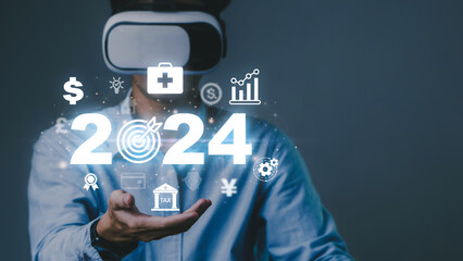 2024 planning,health and goals concept.Business man using Virtual Reality Glasses and creative New...