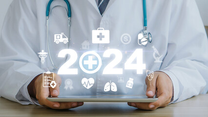Happy new year 2024 medical and health care concept.Doctor using tablet with 2024 and medical...