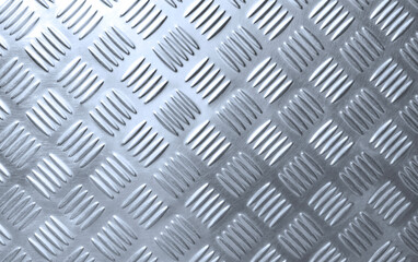 The old silver steel checkered plate background with scratches texture and light reflection on...