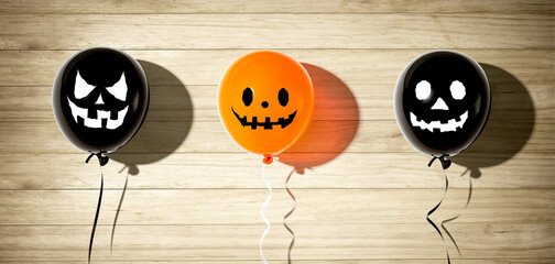 Halloween balloon ghosts with happy faces - flat lay