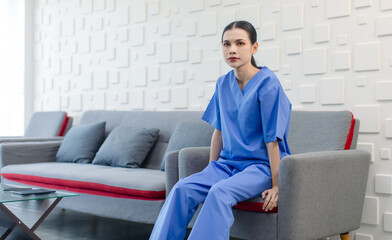 Portrait shot of Asian professional successful skilled talented young female doctor in blue...