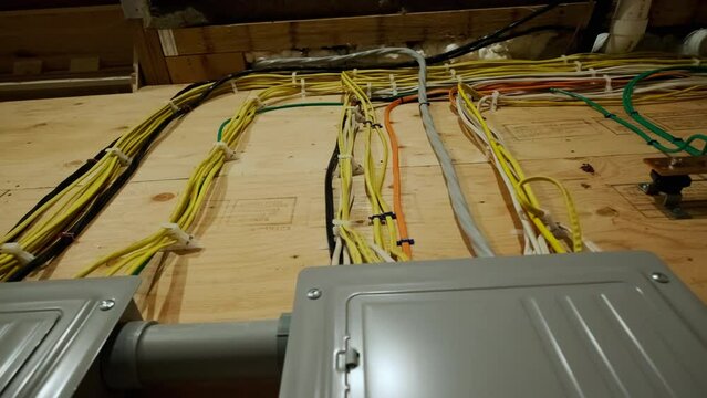 Electrical panel and laid wires in new wooden home construction Close up