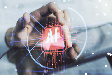 Double exposure of creative artificial Intelligence abbreviation and hand working with a digital...