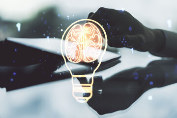 Creative light bulb illustration with human brain and with finger presses on a digital tablet on background, future technology concept. Multiexposure